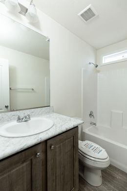 The FAIRPOINT 14602A Guest Bathroom. This Manufactured Mobile Home features 2 bedrooms and 2 baths.