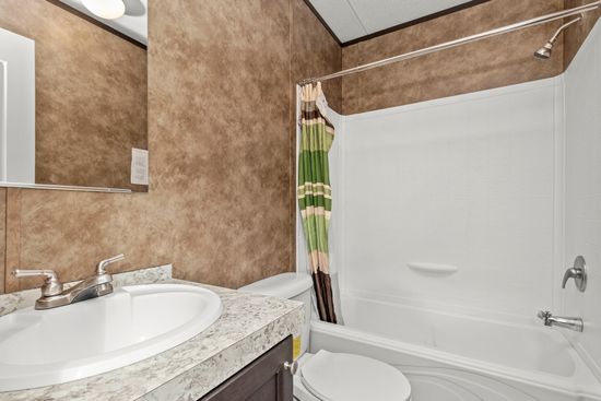 The THE ANNIVERSARY 16 2BED ISLAND Guest Bathroom. This Manufactured Mobile Home features 2 bedrooms and 2 baths.