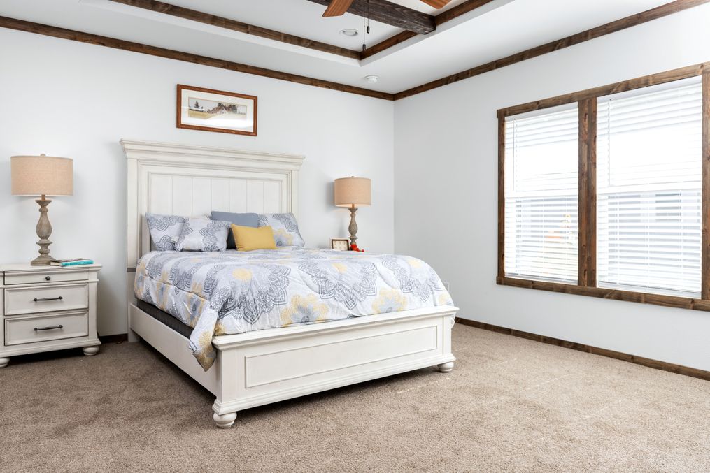 The THE BRAZOS Primary Bedroom. This Manufactured Mobile Home features 3 bedrooms and 2.5 baths.