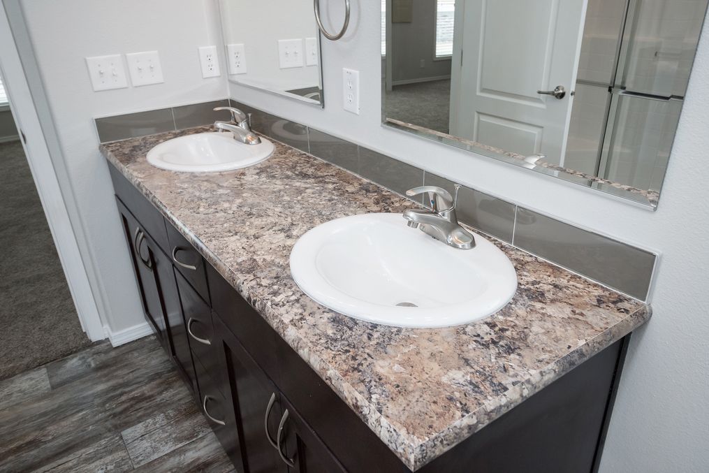 The ENCHANTMENT 3070A Primary Bathroom. This Manufactured Mobile Home features 3 bedrooms and 2 baths.