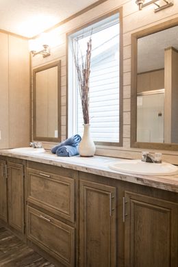 The THE CREEKWOOD Primary Bathroom. This Manufactured Mobile Home features 4 bedrooms and 2 baths.