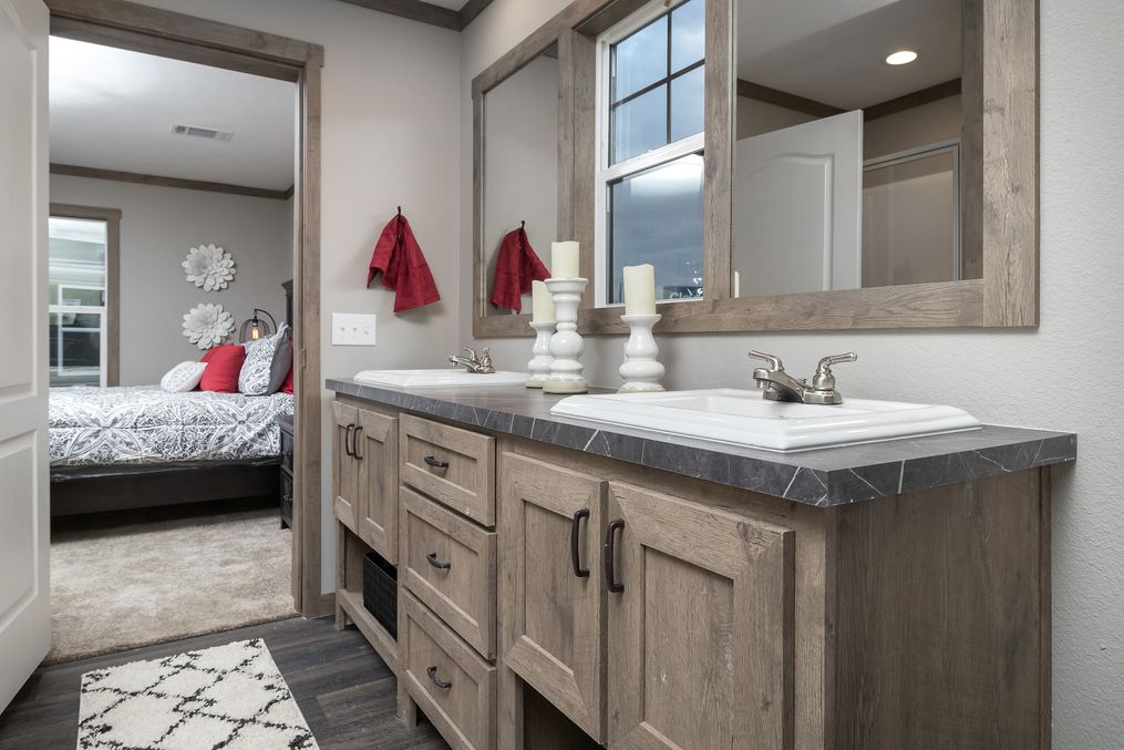The FARMHOUSE 4 Primary Bathroom. This Manufactured Mobile Home features 4 bedrooms and 2 baths.