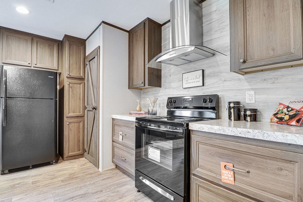 The THE ANNIVERSARY 2.1 Kitchen. This Manufactured Mobile Home features 3 bedrooms and 2 baths.