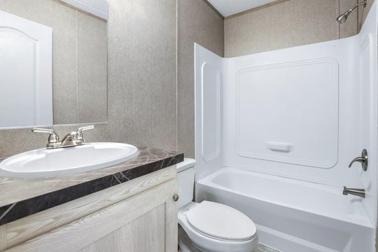 The ANNIVERSARY 16763F Guest Bathroom. This Manufactured Mobile Home features 3 bedrooms and 2 baths.