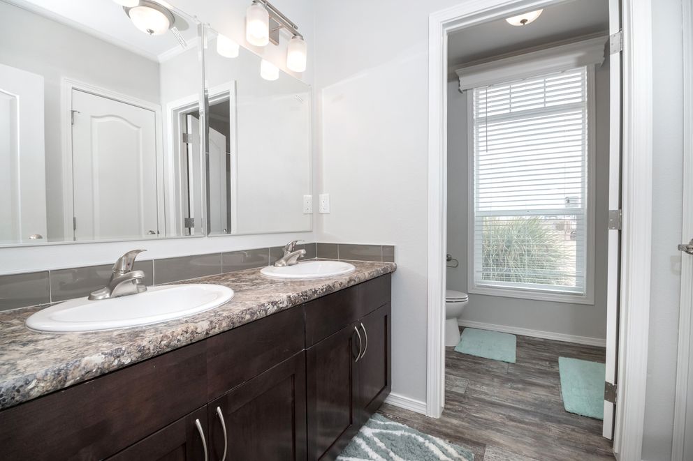 The ENCHANTMENT 3070A Primary Bathroom. This Manufactured Mobile Home features 3 bedrooms and 2 baths.