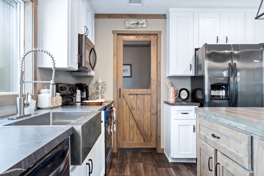 The COUNTRY COTTAGE Kitchen. This Manufactured Mobile Home features 3 bedrooms and 2 baths.