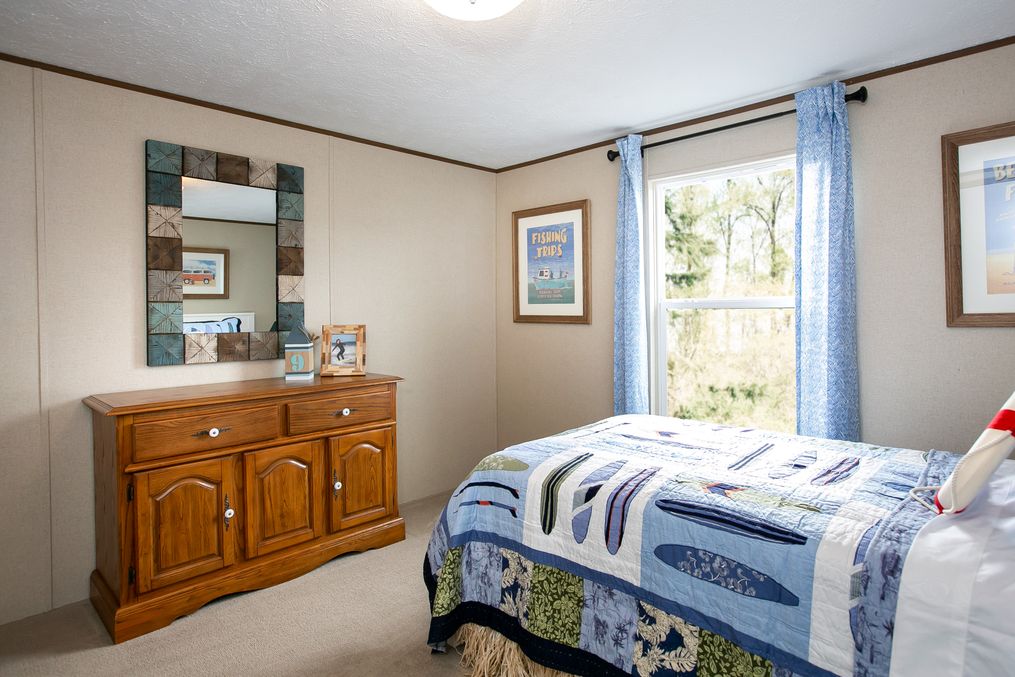 The TRIUMPH Guest Bedroom. This Manufactured Mobile Home features 5 bedrooms and 3 baths.