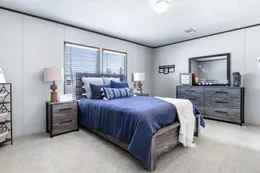 The ABSOLUTE VALUE Primary Bedroom. This Manufactured Mobile Home features 4 bedrooms and 2 baths.