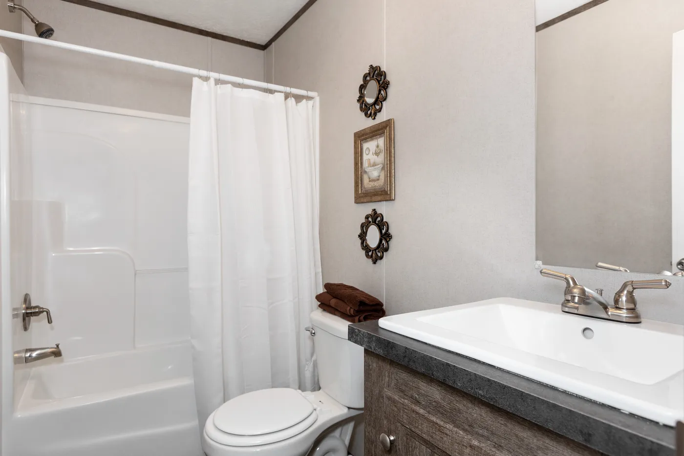 The THE BREEZE Guest Bathroom. This Manufactured Mobile Home features 3 bedrooms and 2 baths.