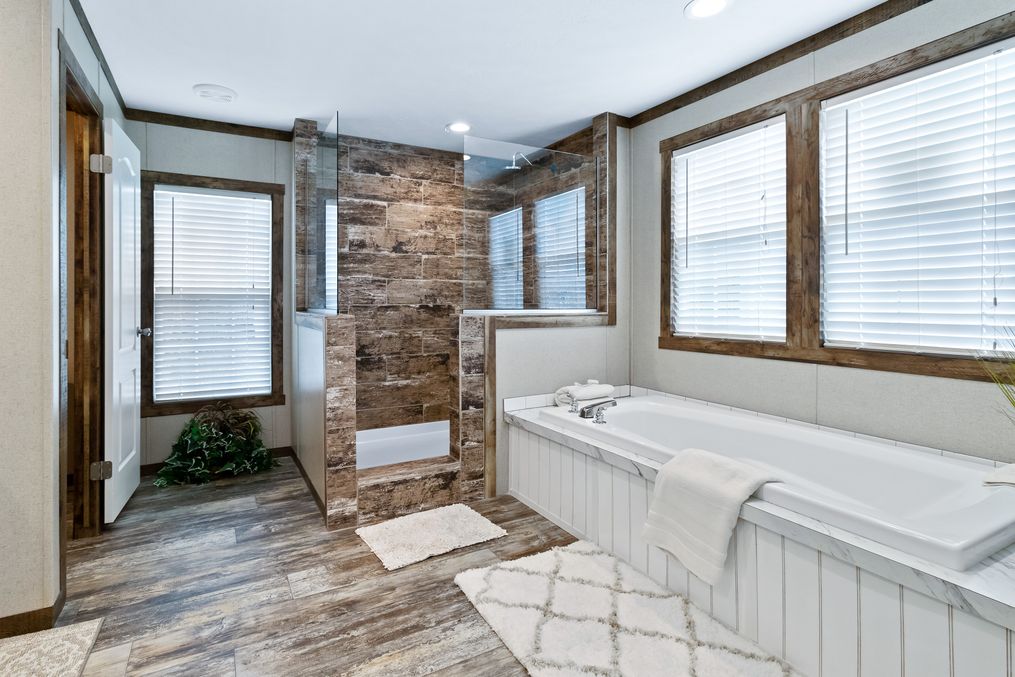 The THE MAVERICK Primary Bathroom. This Manufactured Mobile Home features 4 bedrooms and 2 baths.