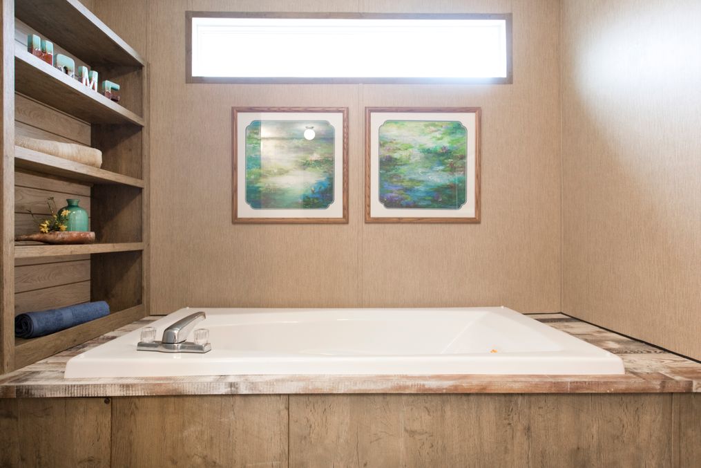 The THE CREEKWOOD Primary Bathroom. This Manufactured Mobile Home features 4 bedrooms and 2 baths.