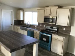 The 2022 COLUMBIA RIVER Kitchen. This Manufactured Mobile Home features 3 bedrooms and 2 baths.