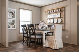 The FARMHOUSE BREEZE 72 Dining Area. This Manufactured Mobile Home features 4 bedrooms and 2 baths.