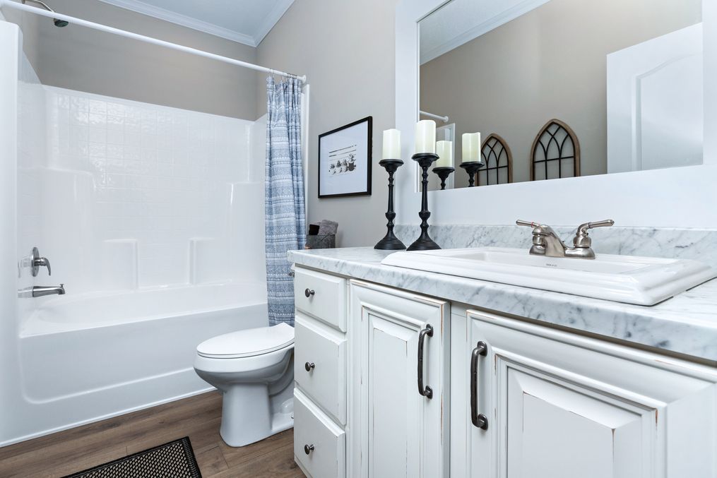 The THE LANEY Guest Bathroom. This Manufactured Mobile Home features 3 bedrooms and 3 baths.