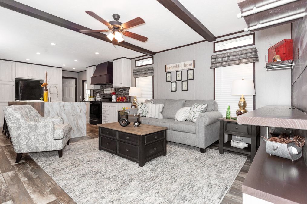 The THE GRANITE RIDGE Living Room. This Manufactured Mobile Home features 3 bedrooms and 2 baths.
