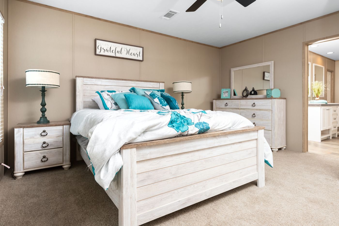 The FARMHOUSE FLEX Primary Bedroom. This Manufactured Mobile Home features 3 bedrooms and 2.5 baths.
