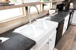 The FARMHOUSE FLEX Kitchen. This Manufactured Mobile Home features 3 bedrooms and 2.5 baths.
