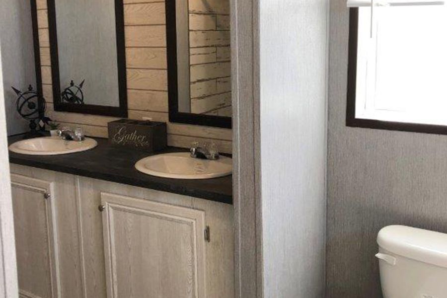 The THE MEADOWBROOK Master Bathroom. This Manufactured Mobile Home features 4 bedrooms and 2 baths.