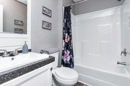 The THE ANNIVERSARY FARMHOUSE Guest Bathroom. This Manufactured Mobile Home features 3 bedrooms and 2 baths.