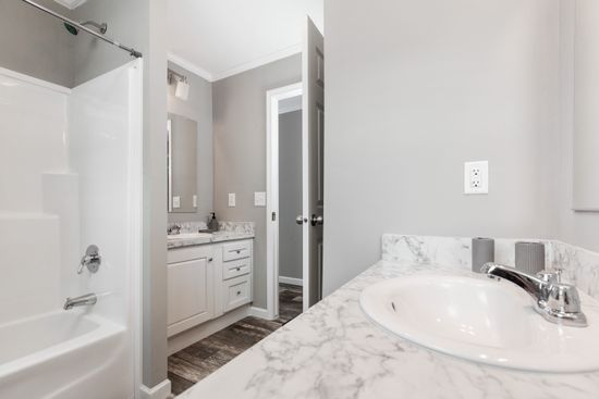 The 4621 "THE CHARLESTON" 7628 Guest Bathroom. This Manufactured Mobile Home features 4 bedrooms and 2 baths.