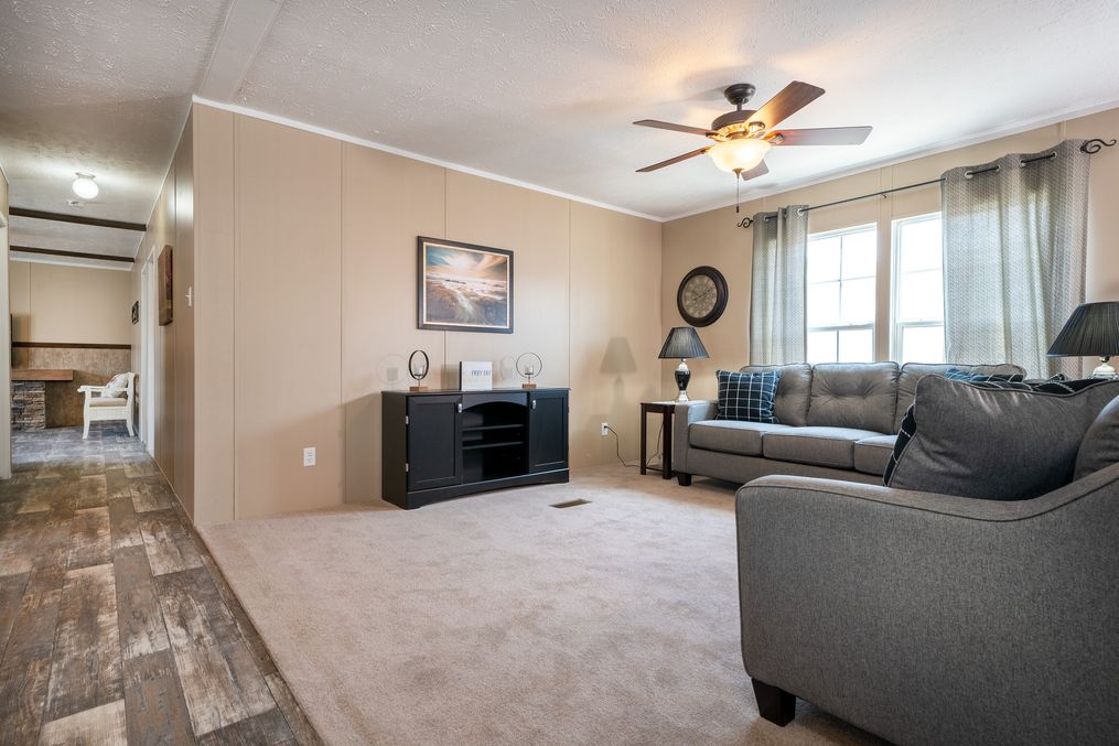 The TRADITION 60B Living Room. This Manufactured Mobile Home features 3 bedrooms and 2 baths.