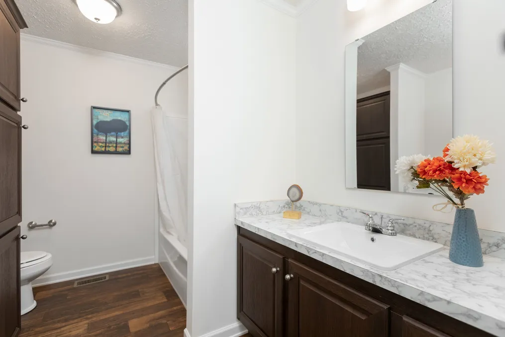 The 1321 CLASSIC Guest Bathroom. This Manufactured Mobile Home features 4 bedrooms and 2 baths.