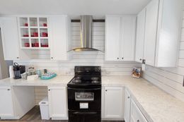 The BREEZE FARMHOUSE 72 Kitchen. This Manufactured Mobile Home features 4 bedrooms and 2 baths.