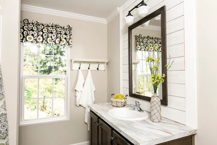 The FREEDOM FARM HOUSE  32X60 Guest Bathroom. This Manufactured Mobile Home features 3 bedrooms and 2 baths.