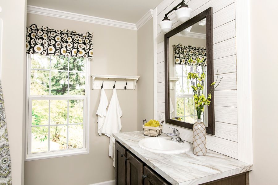 The FREEDOM FARM HOUSE  32X60 Guest Bathroom. This Manufactured Mobile Home features 3 bedrooms and 2 baths.