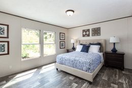 The THE BREEZE 2.5         CLAYTON Primary Bedroom. This Manufactured Mobile Home features 4 bedrooms and 2 baths.