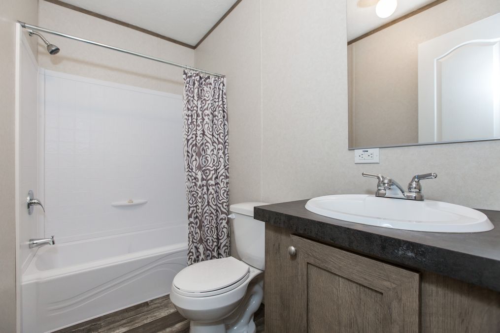 The THE NEW BREEZE Guest Bathroom. This Manufactured Mobile Home features 3 bedrooms and 2 baths.