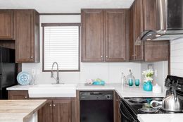The THE ANNIVERSARY ISLANDER Kitchen. This Manufactured Mobile Home features 3 bedrooms and 2 baths.