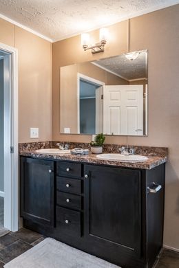 The 5604 ENTERPRISE 4 6428 Primary Bathroom. This Manufactured Mobile Home features 3 bedrooms and 2 baths.