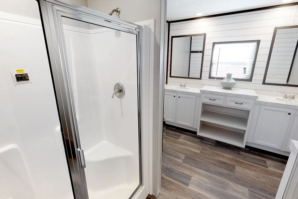 The BREEZE FARMHOUSE 72 Master Bathroom. This Manufactured Mobile Home features 4 bedrooms and 2 baths.