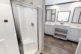 The BREEZE FARMHOUSE 72 Primary Bathroom. This Manufactured Mobile Home features 4 bedrooms and 2 baths.