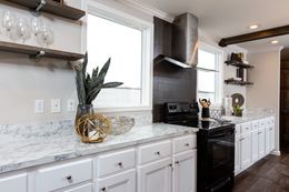 The THE FREEDOM SOHO Kitchen. This Manufactured Mobile Home features 3 bedrooms and 2 baths.