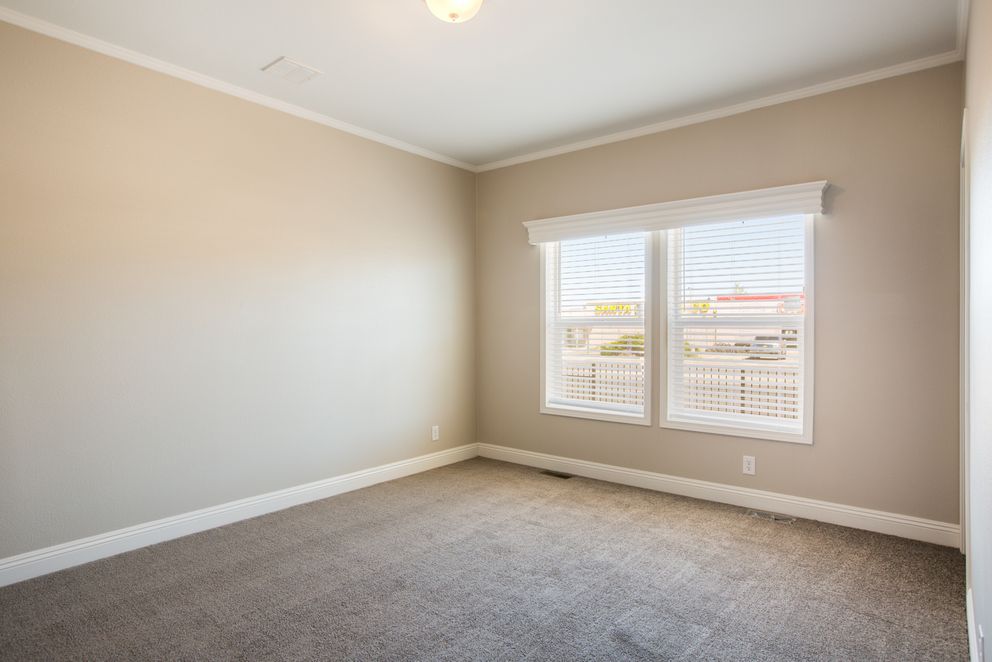 The EDGEWOOD Guest Bedroom. This Manufactured Mobile Home features 3 bedrooms and 2 baths.