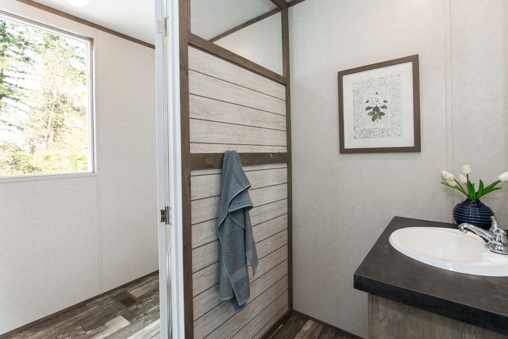 The THE NEW BREEZE II Guest Bathroom. This Manufactured Mobile Home features 4 bedrooms and 2 baths.