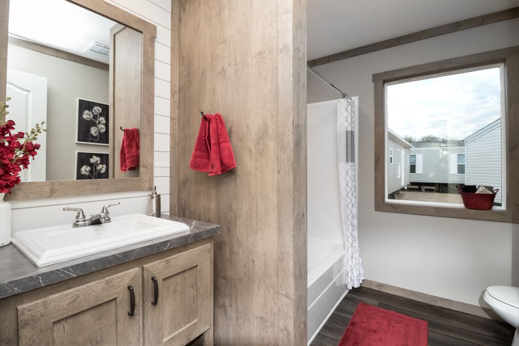 The FARMHOUSE 4 Guest Bathroom. This Manufactured Mobile Home features 4 bedrooms and 2 baths.