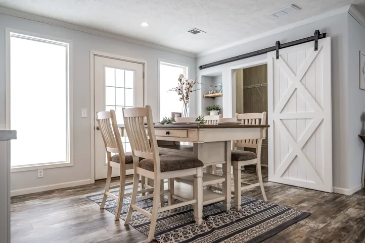 The THE LEAHY Dining Area. This Manufactured Mobile Home features 4 bedrooms and 2 baths.