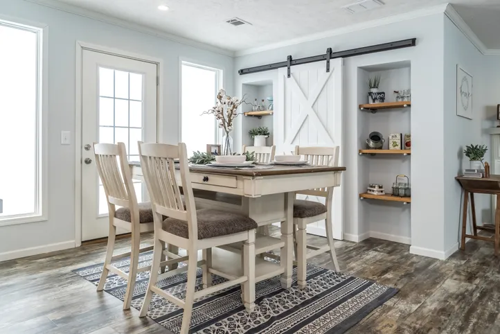 The THE LEAHY Dining Area. This Manufactured Mobile Home features 4 bedrooms and 2 baths.