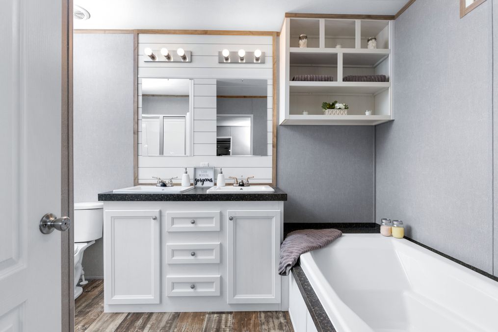 The THE ANNIVERSARY FARMHOUSE Master Bathroom. This Manufactured Mobile Home features 3 bedrooms and 2 baths.