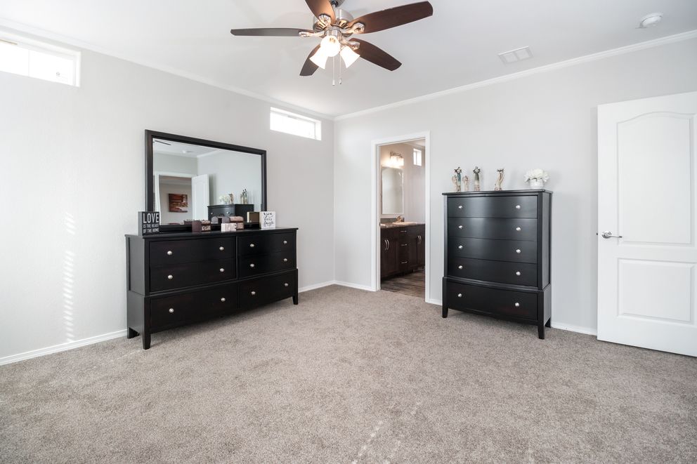 The ENCHANTMENT 3070A Primary Bedroom. This Manufactured Mobile Home features 3 bedrooms and 2 baths.
