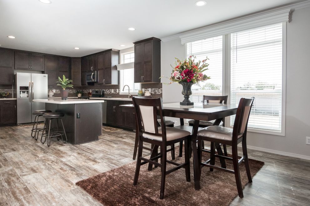 The ENCHANTMENT 3070A Dining Area. This Manufactured Mobile Home features 3 bedrooms and 2 baths.