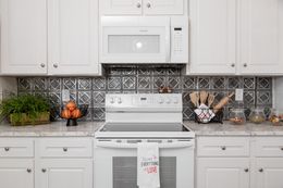 The 1439 CAROLINA "MAGNOLIA" Kitchen. This Manufactured Mobile Home features 3 bedrooms and 2 baths.