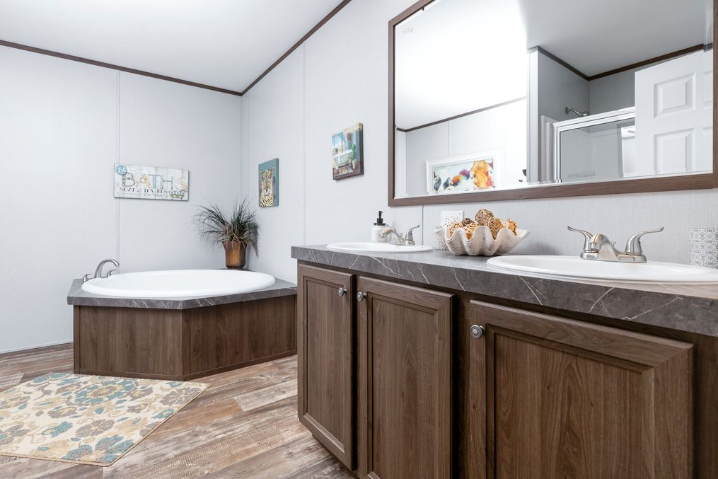 The CRAZY EIGHTS Primary Bathroom. This Manufactured Mobile Home features 4 bedrooms and 2 baths.