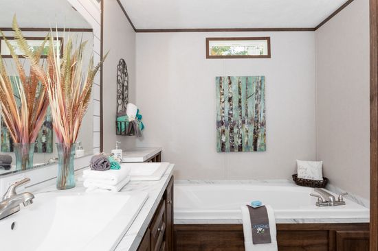 The THE ANNIVERSARY ISLANDER Primary Bathroom. This Manufactured Mobile Home features 3 bedrooms and 2 baths.