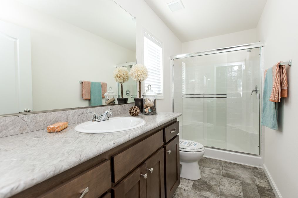 The FAIRPOINT 24403A Primary Bathroom. This Manufactured Mobile Home features 3 bedrooms and 2 baths.