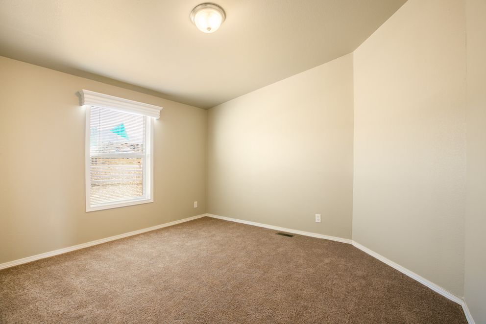 The THE WAVE Guest Bedroom. This Manufactured Mobile Home features 4 bedrooms and 2 baths.