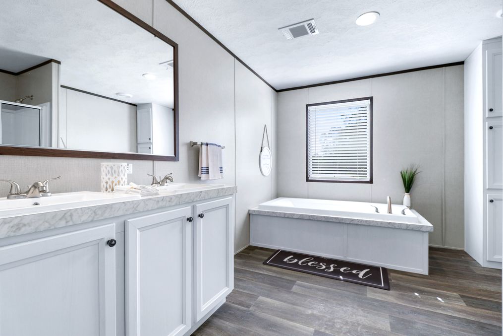 The ABSOLUTE VALUE Master Bathroom. This Manufactured Mobile Home features 4 bedrooms and 2 baths.